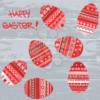 Red doodle Easter eggs on wooden background