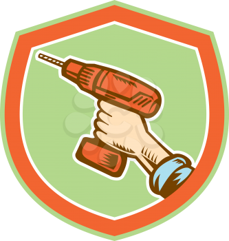 Illustration of a handyman carpenter builder hand holding a cordless drill set inside shield crest shape isolated on white done in retro woodcut style.
