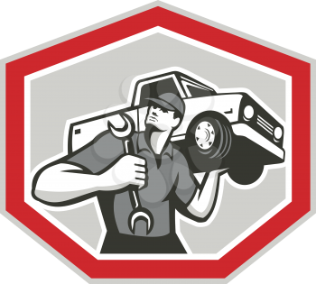 Illustration of an automotive mechanic carrying pick-up truck car vehicle on shoulder holding spanner wrench set inside shield crest shape done in retro style.