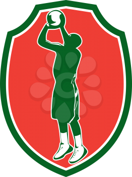 Illustration of a basketball player jump shot jumper shooting jumping set inside shield crest on isolated background done in retro style. 