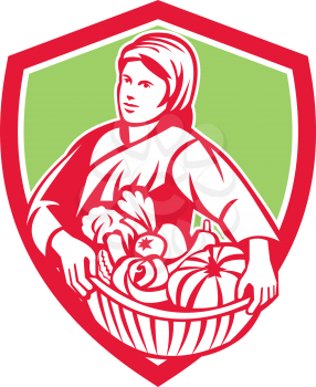 Illustration of a female organic farmer carrying basket full of vegetables fruits harvest looking to the side set inside shield crest on isolated background done in retro style. 