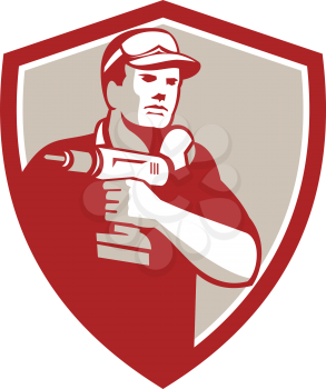 Illustration of a handyman holding cordless power drill set inside shield crest on isolated on background done in retro style.