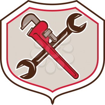 Cartoon style illustration of a pipe adjustable monkey wrench crossed with spanner set inside shield crest on isolated white background. 