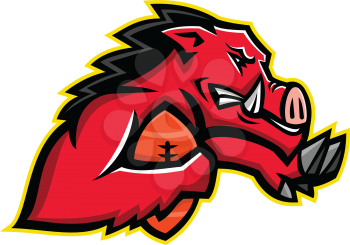 Mascot icon illustration of bust of a red wild boar or razorback, a half-wild pig breed common in the southern US, running with American football ball fend off with stiff-arm viewed side on isolated background.