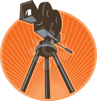 Icon retro style illustration of a Vintage 35mm Motion Picture Camera, film or movie camera set on tripod viewed from low angle worm's eye view set inside circle with sunburst on isolated background.