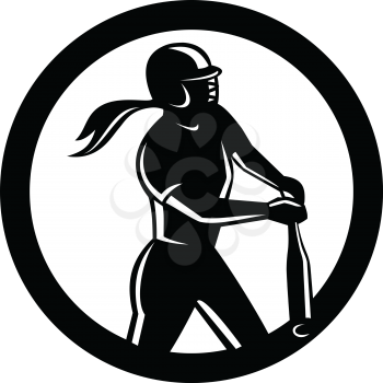 Mascot icon illustration of a female softball player batting with bat set inside circle viewed from side on isolated background in retro style done in black and white.