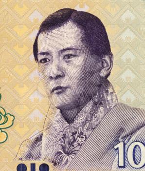 Royalty Free Photo of Jigme Singye Wangchuck (1955-) on 10 Ngultrum 2006 Banknote from Bhutan. King of Bhutan during 1972-2006.