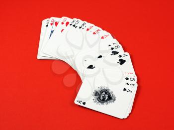 Royalty Free Photo of Playing Cards on Red