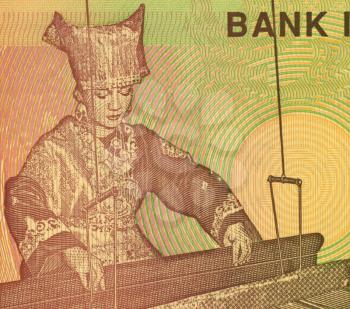 Royalty Free Photo of Woman at Hand Loom on 5000 Rupiah 2008 Banknote from Indonesia.