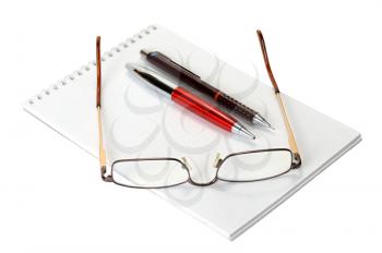 Open a blank worksheet notebook, pen, pencil and eyeglasses on a white background.