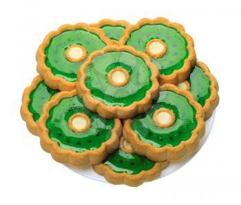 Brown Cookies with green jelly on a white plate, isolated