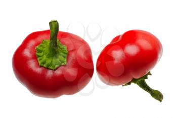 Two small round red peppers on a white background, isolated.