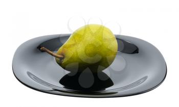 Pear on a black platte on white background, isolated.