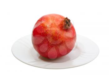 Royalty Free Photo of a Pomegranate on a White Plate