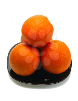 Four oranges and their reflection on a black plate on a white background