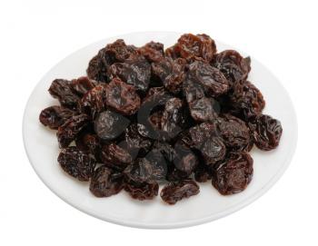 Big brown raisins on a white plate on a white background