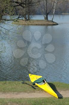 Royalty Free Photo of a Yellow Kayak at the Water's Edge