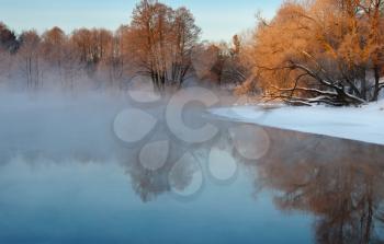 Royalty Free Photo of a Frosty Autumn Morning With Fog Over the Water