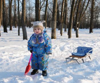 Royalty Free Photo of a Little Girl With a Sled