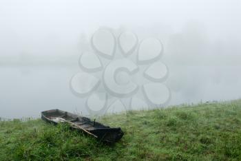 Royalty Free Photo of Fog Over Water and a Boat in the Foreground