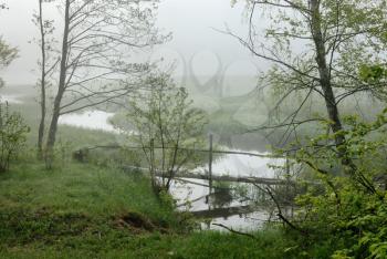Royalty Free Photo of People By a River on a Foggy Morning