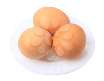 Three brown eggs on a white background, isolated.