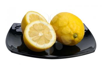 Two lemons on a black plate, isolated