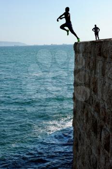 Teens, jumping into the sea from a height of city walls of Acre.