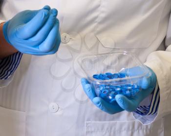 Scientists hand holds disposable caps for chromatography;