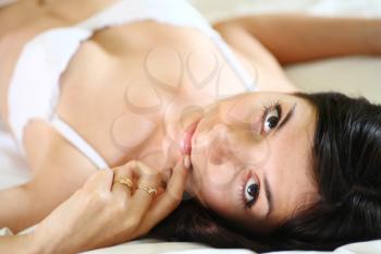 european fashion model posing in bed wearing white underwear