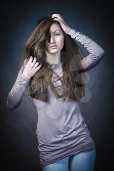 studio portrait of woman with long hair