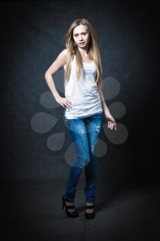 a young blonde wearing jeans and jacket full body shot