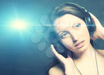 Sexy woman with headphones listening to music