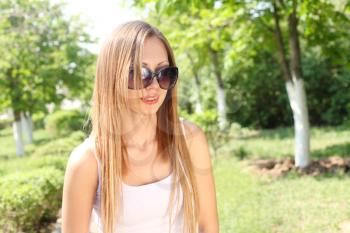 Portrait of a beautiful sexy woman outdoors in sunglasses