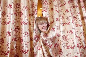 Woman smiling and peeking out from dressing room