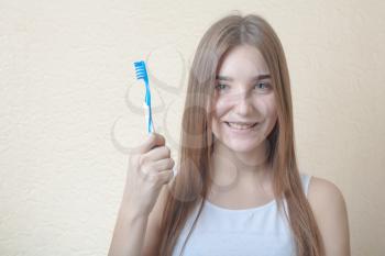 Dental Hygiene Concept - A head and shoulders view of a blond woman with teeth brush