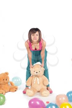 A beautiful and sexy 20-25 years brunette girl with teddy bear on white background