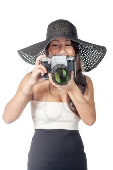 Young caucasian woman looking like Lady vintage weared with old film camera with very big lens isolated over white background