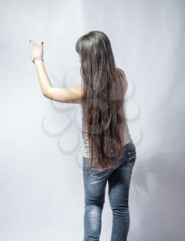 japan girl gesture on white in studio back view pointing torso shot