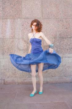 redhead 20s women in blue tank top and skirt dancing salsa outdoor in loneliness, summertime, day