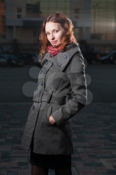 redhead 20s women standing outdoor in autumn park, weared scarf and coat