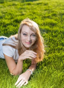 blond on grass smiling