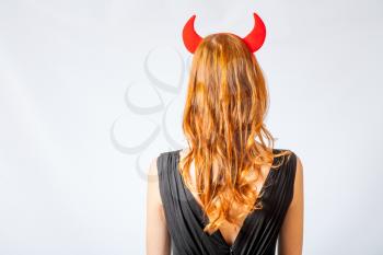 redhead girl with red  horns looks like pretty Devil