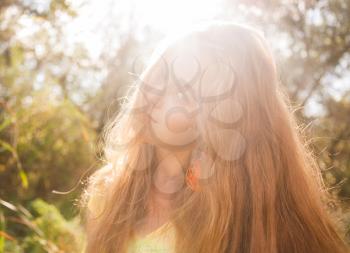 Colorized image with lens flares. Backlit. Pretty blonde outdoors. Colorized image
