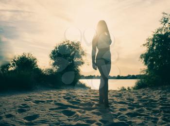 Women on sandy beach full body silhouette shot
