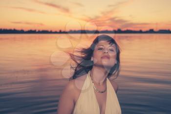 Retro looking women at sunset with her hair flying by find