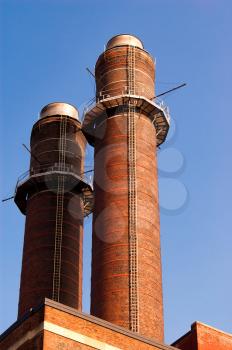 Factory chimneys (chimney-stalk) against blue sky