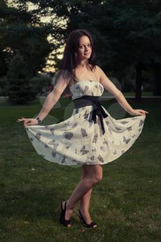 Sexy brunette posing outdoors weared cute summer dress