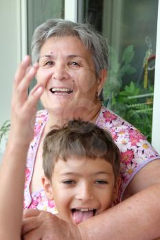 Grandson and his grandmother having fun together