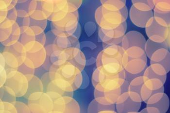 Golden bokeh. Blurred lights of gold yellow color. Xmas wallpaper